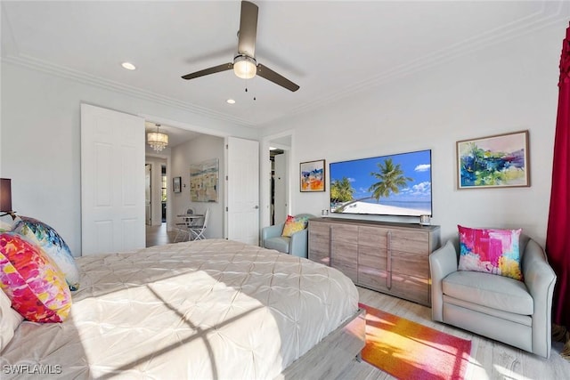 bedroom with ceiling fan with notable chandelier, ornamental molding, and light hardwood / wood-style flooring