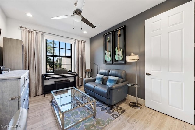 living room with ceiling fan and light hardwood / wood-style floors