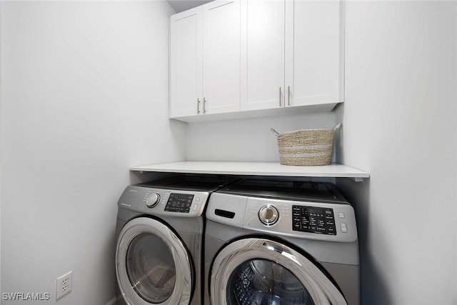 laundry area featuring cabinets and separate washer and dryer