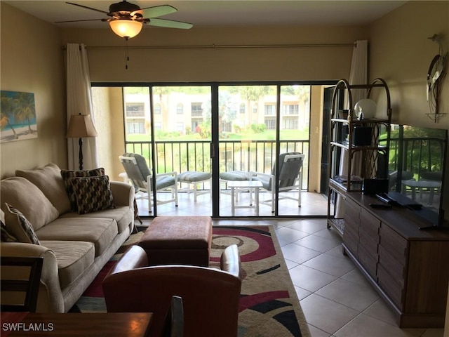 tiled living room featuring ceiling fan and a healthy amount of sunlight