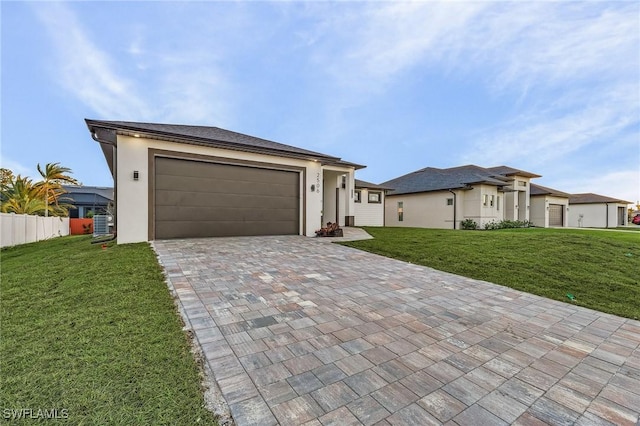 view of front of home with a garage and a front lawn