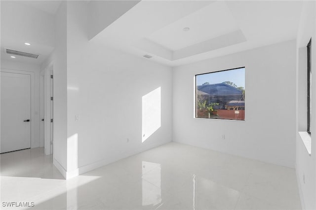 spare room featuring a raised ceiling