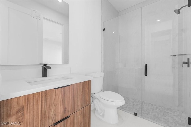 bathroom with a shower with door, vanity, and toilet