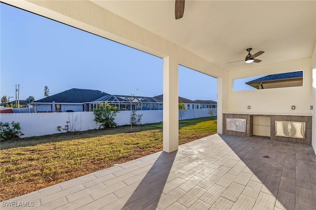 view of patio / terrace featuring ceiling fan and an outdoor kitchen