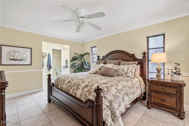 tiled bedroom with connected bathroom, ceiling fan, and ornamental molding