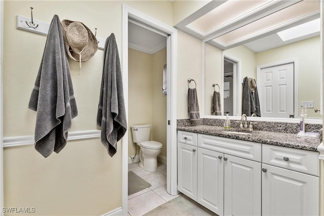 bathroom featuring tile patterned flooring, vanity, and toilet