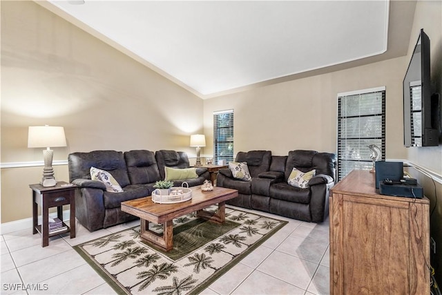 living room featuring lofted ceiling and light tile patterned floors