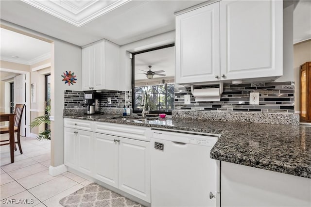 kitchen with white dishwasher, ceiling fan, white cabinets, and backsplash