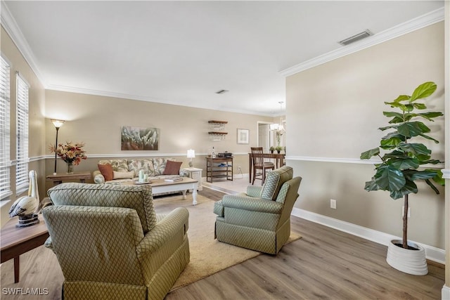 living room featuring hardwood / wood-style flooring and ornamental molding