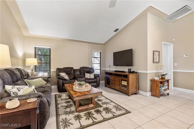 tiled living room with high vaulted ceiling