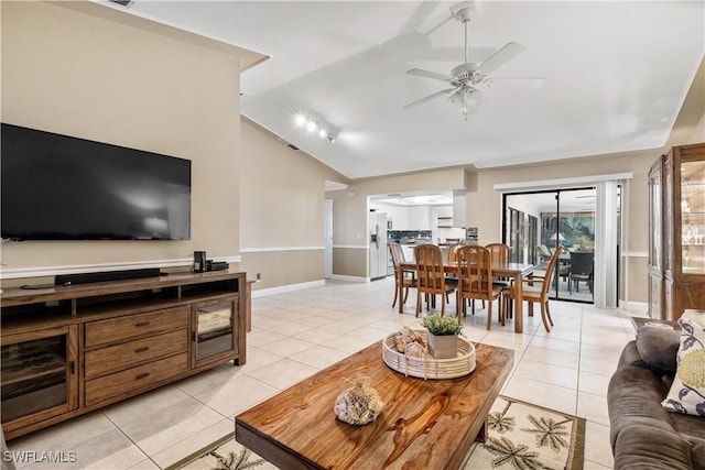 tiled living room with ceiling fan and lofted ceiling