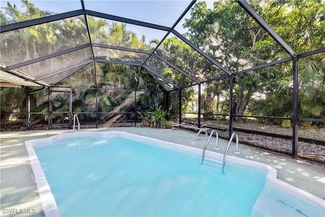 view of swimming pool featuring a lanai