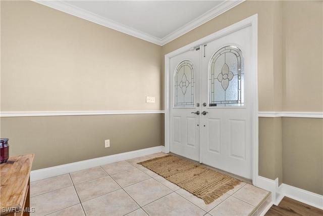 foyer entrance featuring light tile patterned floors and ornamental molding