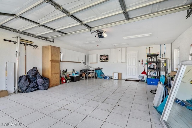 garage featuring a garage door opener and water heater