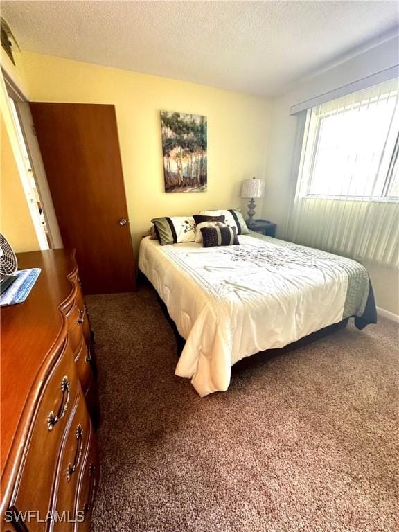 carpeted bedroom with a textured ceiling