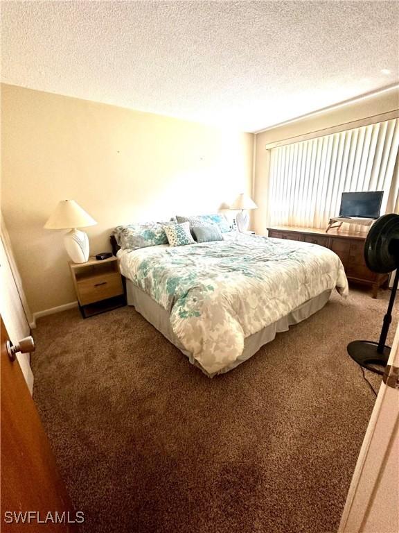 carpeted bedroom with a textured ceiling