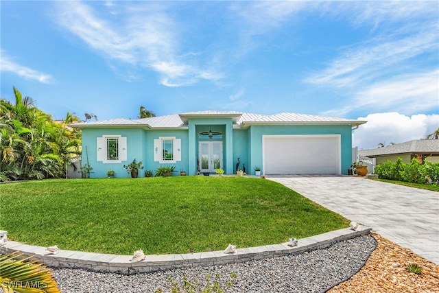 ranch-style house featuring a front yard and a garage