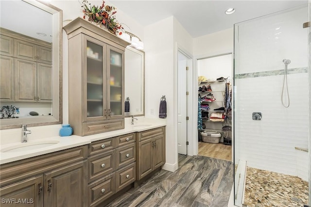 bathroom featuring vanity, wood-type flooring, and walk in shower