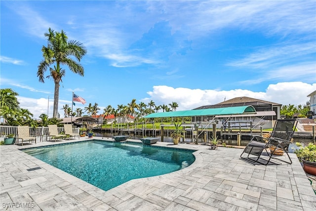 view of swimming pool with a water view and a patio