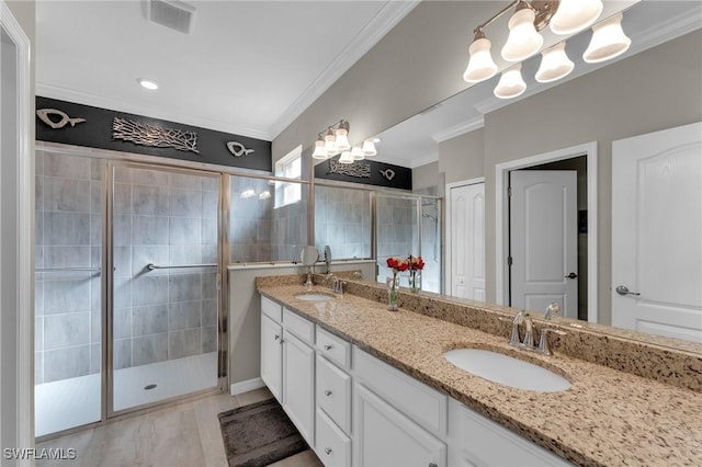 bathroom with tile patterned floors, vanity, an enclosed shower, and ornamental molding