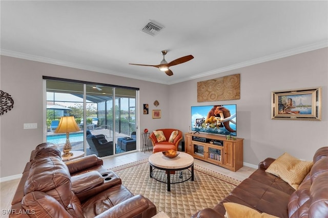 living room with ceiling fan, light tile patterned floors, and ornamental molding