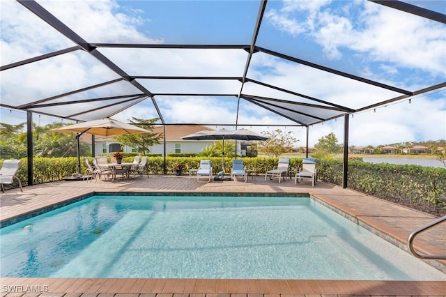 view of pool featuring a lanai, a water view, and a patio