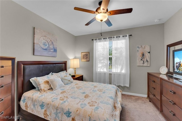 bedroom featuring light carpet and ceiling fan