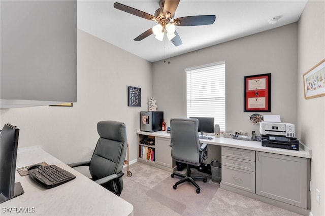 carpeted office space with ceiling fan