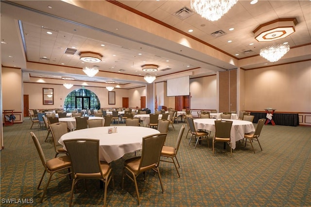 dining room with a raised ceiling, crown molding, and dark carpet