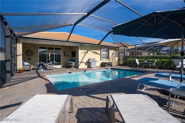 view of swimming pool featuring a lanai and a patio area