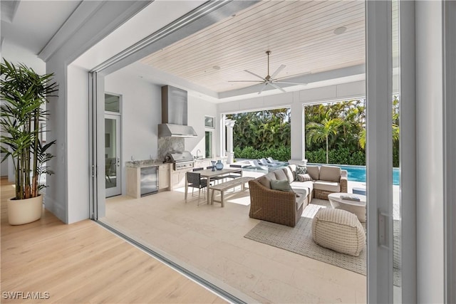 view of patio / terrace featuring outdoor lounge area, ceiling fan, grilling area, and exterior kitchen