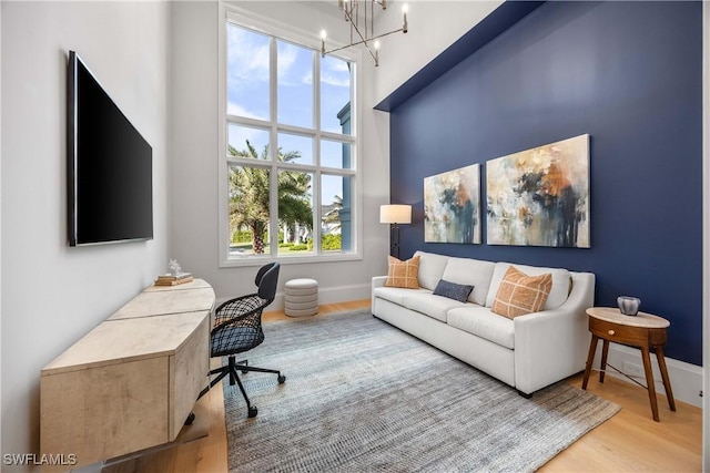 home office featuring a chandelier and light hardwood / wood-style floors