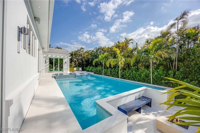 view of swimming pool featuring an in ground hot tub