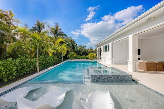 view of pool featuring an in ground hot tub and a patio