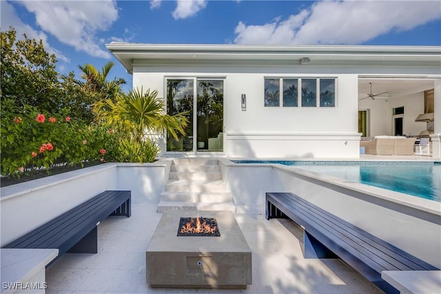 back of house with a patio area, ceiling fan, and an outdoor fire pit