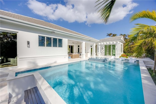 view of swimming pool featuring a patio area and ceiling fan