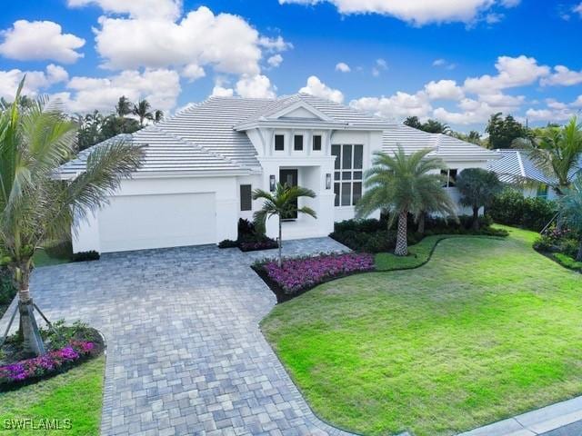 view of front of house featuring a garage and a front lawn