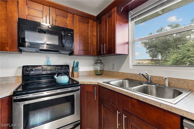 kitchen featuring stainless steel electric range oven and sink