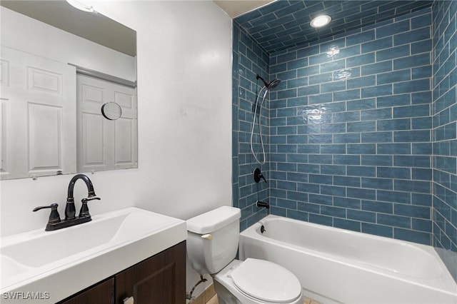 full bathroom with vanity, toilet, and tiled shower / bath