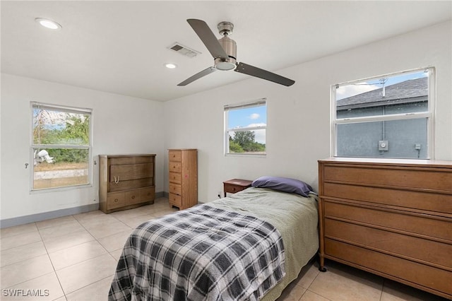 tiled bedroom with multiple windows and ceiling fan