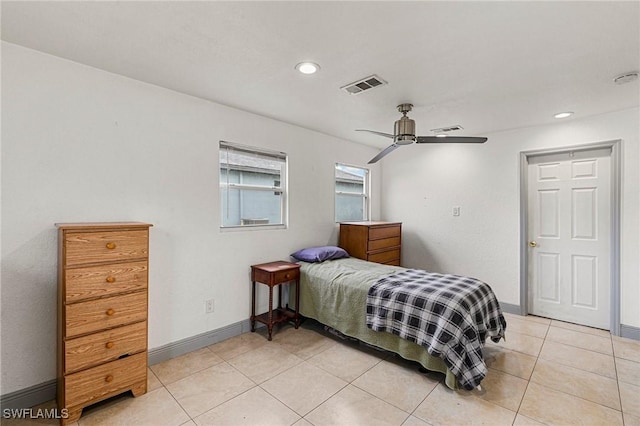 tiled bedroom featuring ceiling fan