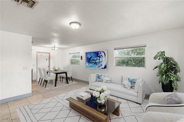 tiled living room with a healthy amount of sunlight and a textured ceiling