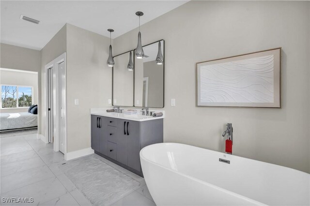 bathroom with vanity and a tub