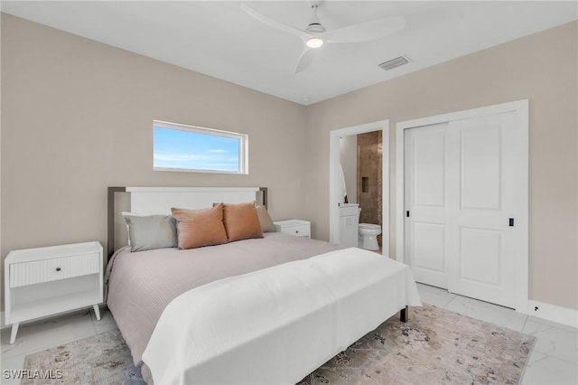 bedroom with visible vents, a ceiling fan, marble finish floor, a closet, and ensuite bath