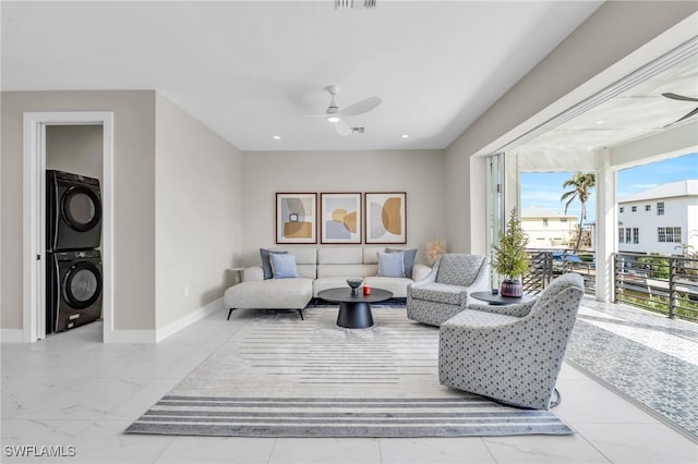 living room with ceiling fan and stacked washing maching and dryer