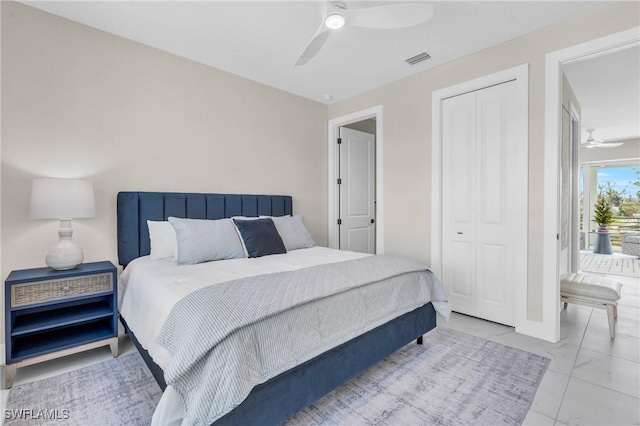 bedroom featuring marble finish floor, a ceiling fan, visible vents, and a closet