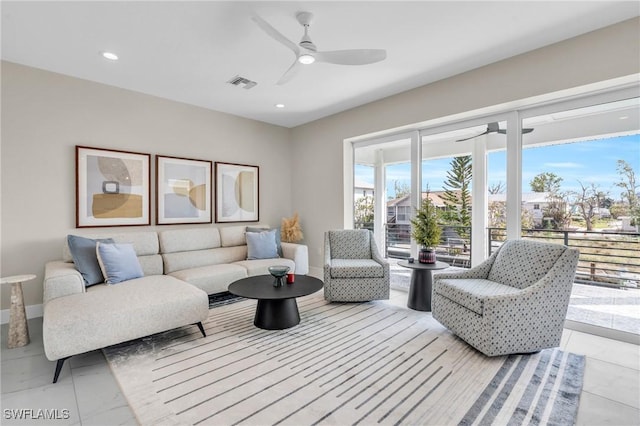 living room with a wealth of natural light and ceiling fan