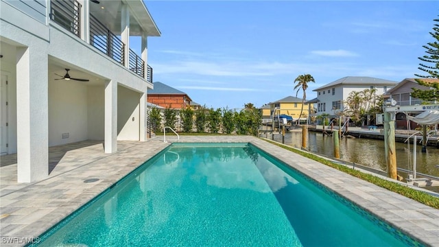 view of swimming pool featuring a patio area and a water view