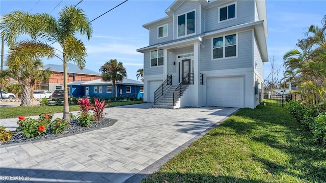 view of front of home featuring a garage and a front lawn