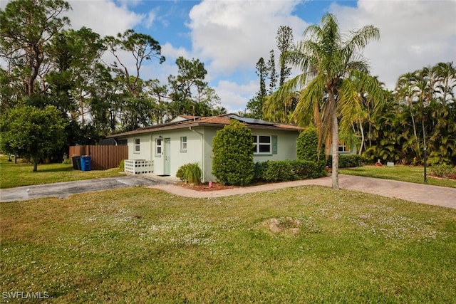 exterior space featuring a lawn and solar panels